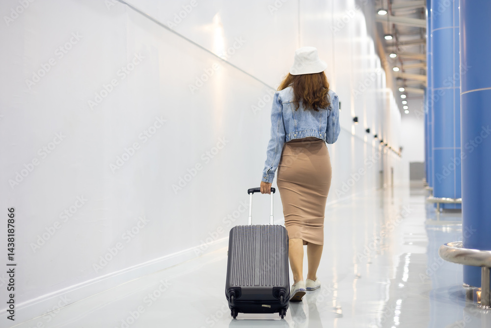 Back view woman hand touching baggage. Stewardess or air hostess carrying suitcase modern airport terminal. flight attendant