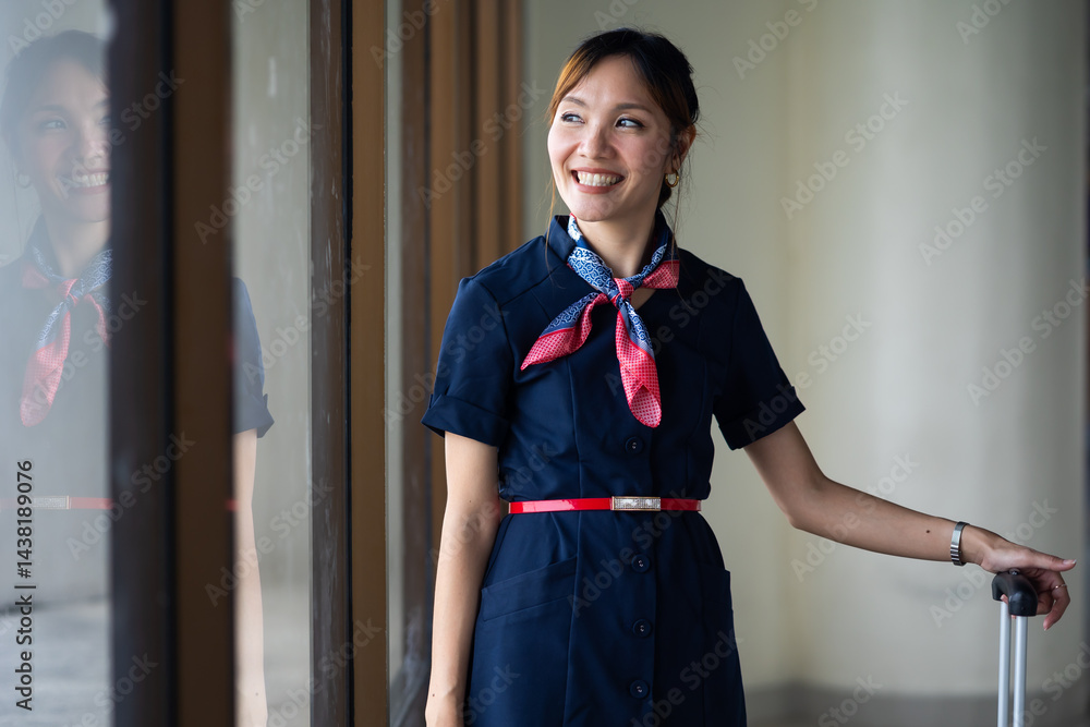 Portrait female Cabin crew or air hostess in airport. Cabin crew, air hostess working in airplane. Service mind. Asian stewardess with suitcase at modern airport terminal. flight attendant