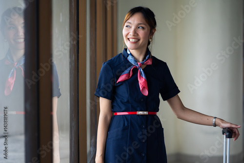 Obraz na płótnie Portrait female Cabin crew or air hostess in airport. Cabin crew, air hostess working in airplane. Service mind. Asian stewardess with suitcase at modern airport terminal. flight attendant w salonie