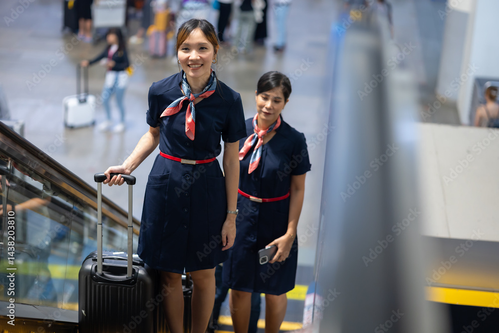 Back view two Cabin crew or air hostess in airport. Cabin crew, air hostess working in airplane. Service mind. Asian stewardess with suitcase at modern airport terminal. flight attendant