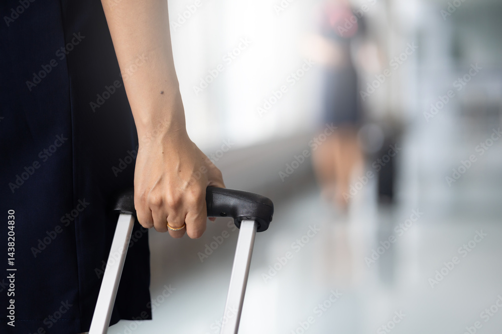 Closeup hand woman Walking in airport. Cabin crew, air hostess working in airplane. Service mind. Asian stewardess with suitcase at modern airport terminal. flight attendant