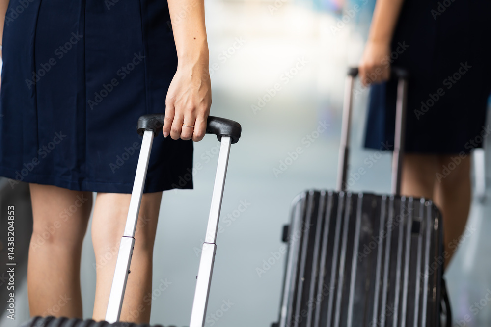 Closeup hand woman Walking in airport. Cabin crew, air hostess working in airplane. Service mind. Asian stewardess with suitcase at modern airport terminal. flight attendant