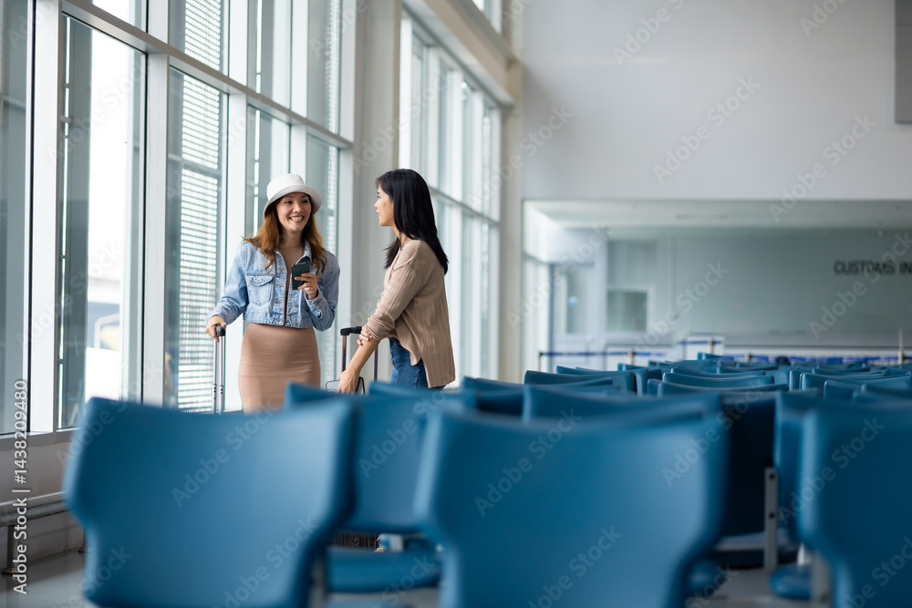 Happy Asian Female Travelling use smartphone. Happy asian woman passenger traveler waiting for departure with suitcase at modern airport terminal