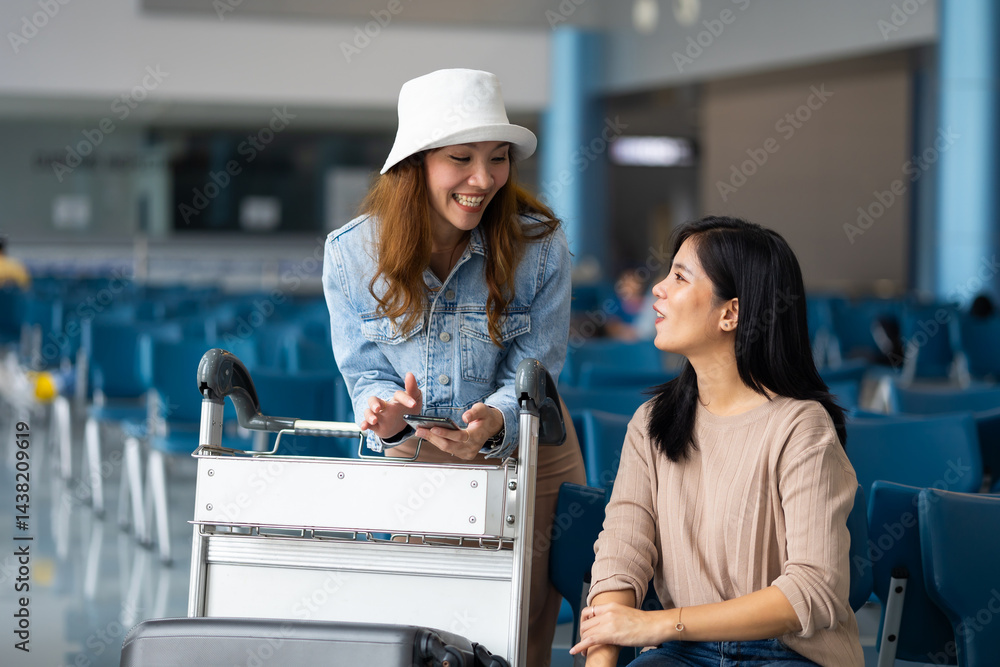 Happy Asian Female Travelling use smartphone. Happy asian woman passenger traveler waiting for departure with suitcase at modern airport terminal