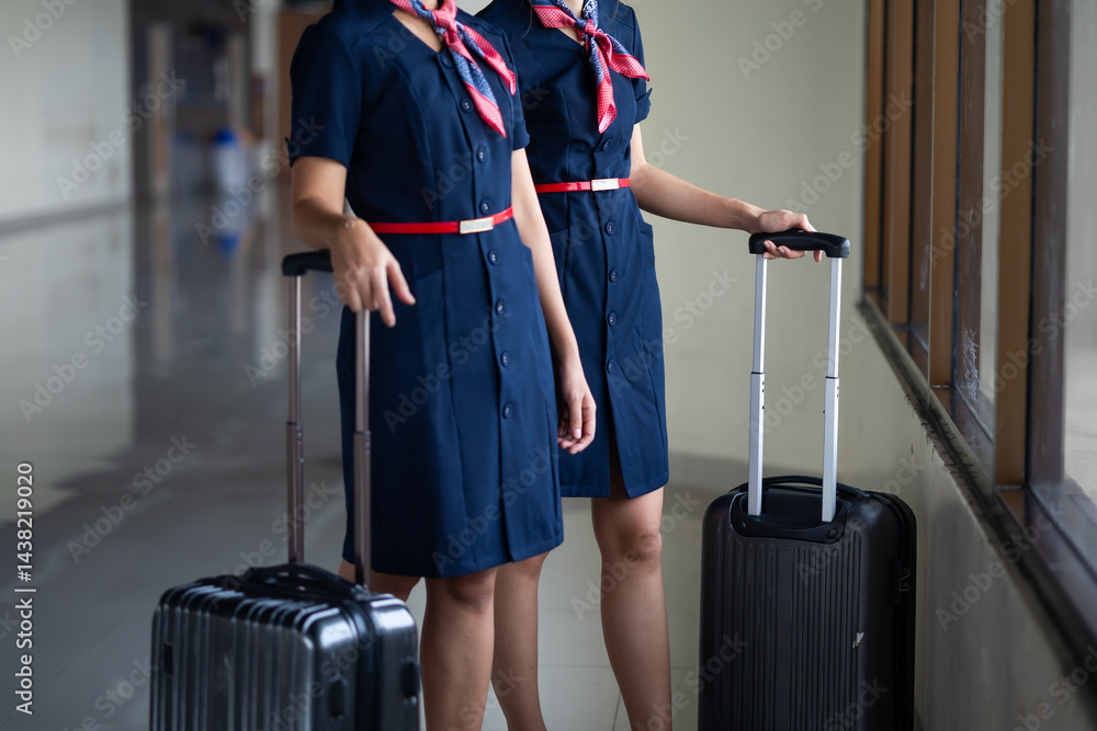 Portrait two Cabin crew or air hostess in airport. Cabin crew, air hostess working in airplane. Service mind. Asian stewardess with suitcase at modern airport terminal. flight attendant