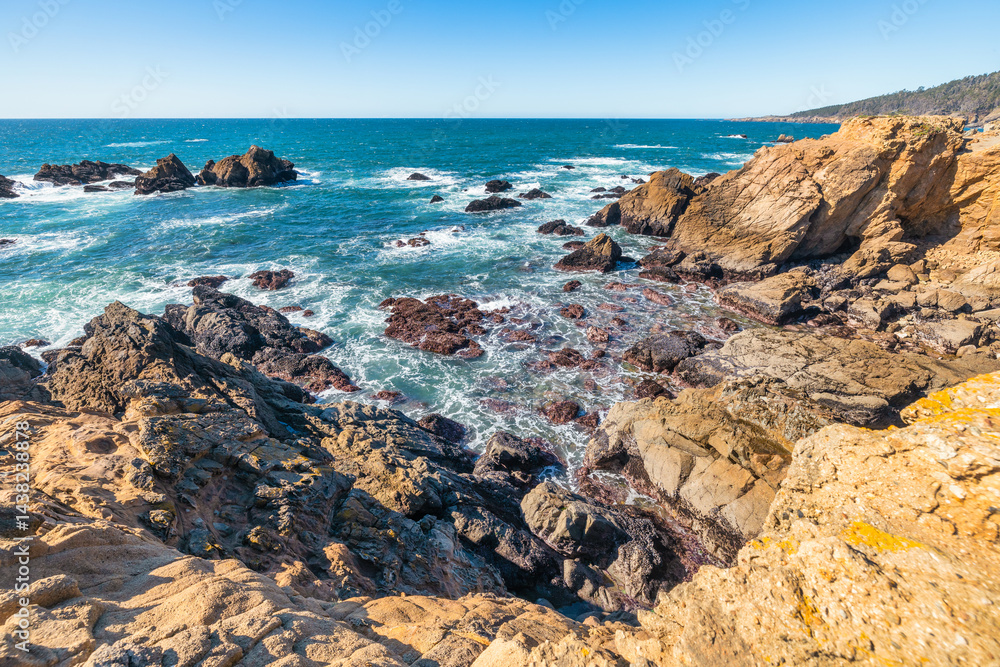 Coastal cliffs along California's Highway 1 in Northern California. Rugged ocean rocks, crashing waves, and a colorful sky create a breathtaking Pacific Coast landscape Coastal cliffs along California's Highway 1 in Northern California. Rugged ocean rocks, crashing waves, and a colorful sky create a breathtaking Pacific Coast landscape