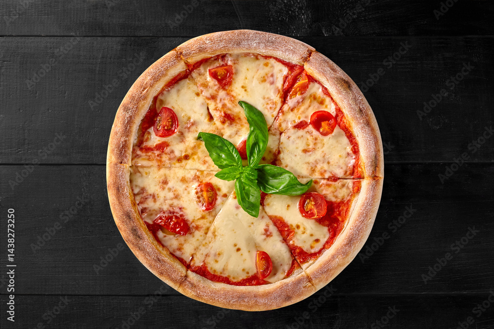 Delicious pizza margherita with tomatoes and basil on dark wooden background