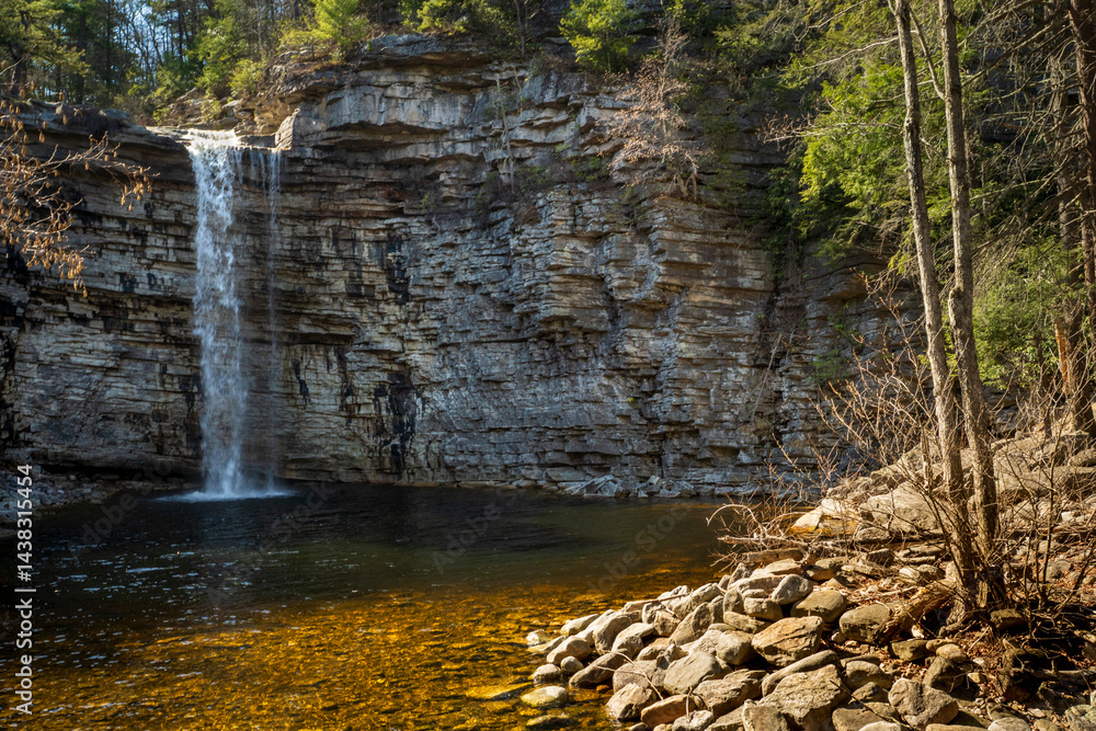 Kerhonkson, NY - US - Apr 23, 2025 Wide view of the Awosting Falls, plunging 60 feet over a dramatic shale cliff into a crystal-clear pool, surrounded by lush forest in Minnewaska State Park, NY.