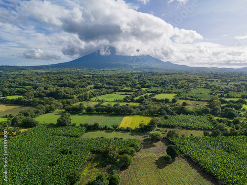 Obraz na płótnie Green agriculture field with volcano on background w salonie
