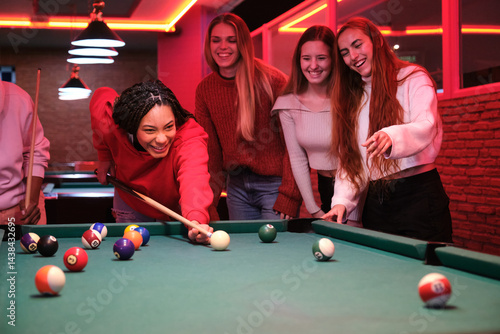 Obraz na płótnie Group of friends having fun playing pool in a vibrant bar, enjoying the nightlife and friendly competition w salonie