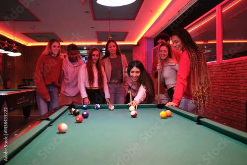 Obraz na płótnie Young people having fun playing pool in a billiard hall with neon lights w salonie
