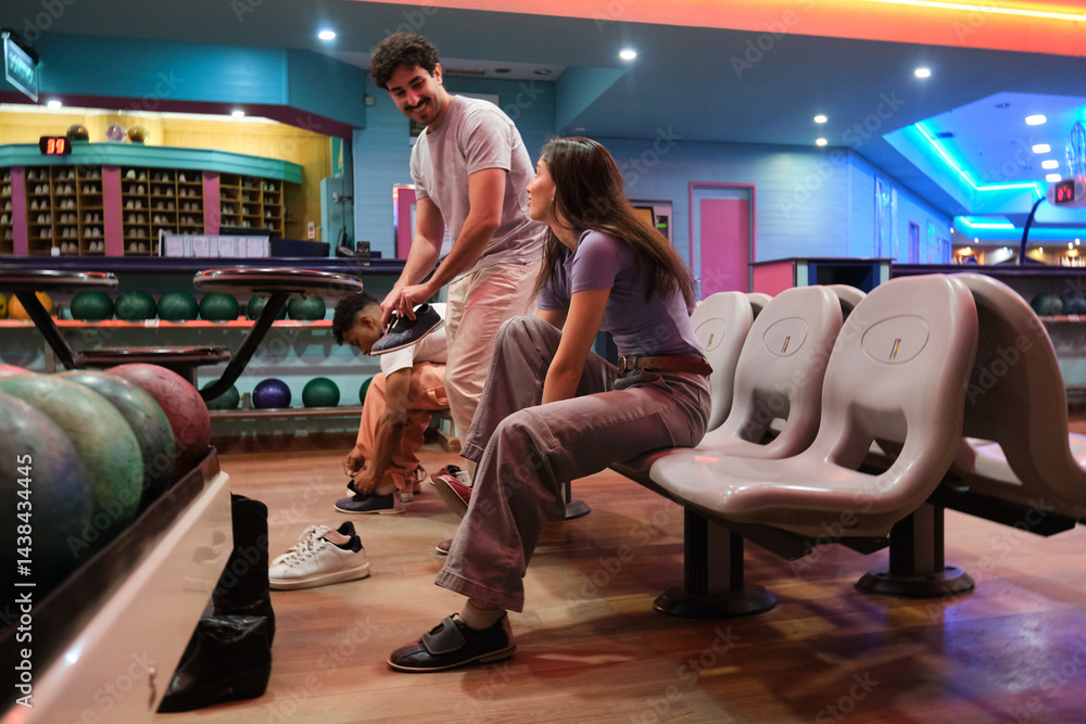 Group of friends wearing bowling shoes at the bowling alley, getting ready for a game