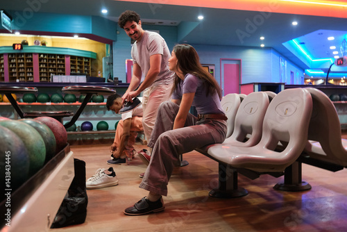Obraz na płótnie Group of friends wearing bowling shoes at the bowling alley, getting ready for a game w salonie