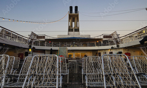 Beautiful breathtaking sunset blue hour twilight panorama at sea with dramatic sky seen from outdoor deck of classic cruiseship cruise ship liner sailing on ocean	