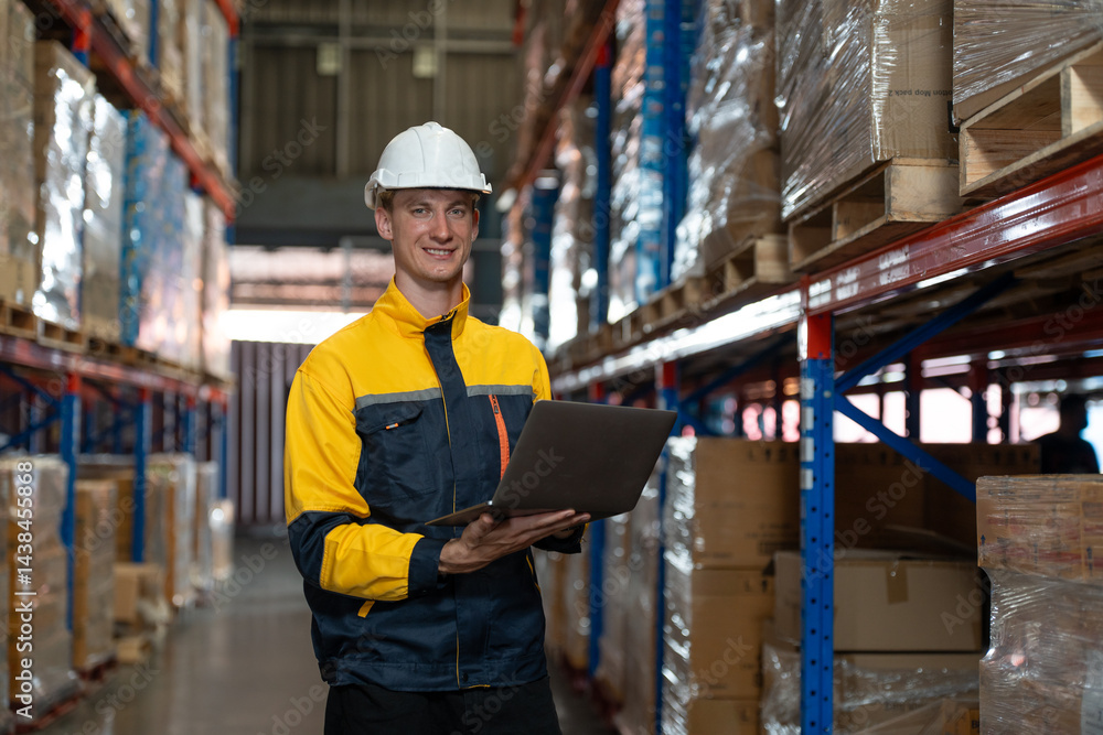 Man warehouse worker wearing uniform and helmet safety standing with clipboard for checking stock products on shelves in warehouse. Logistics, Distribution Center concept Man warehouse worker wearing uniform and helmet safety standing with clipboard for checking stock products on shelves in warehouse. Logistics, Distribution Center concept