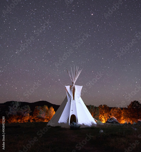 white teepee with stary sky and glowing background