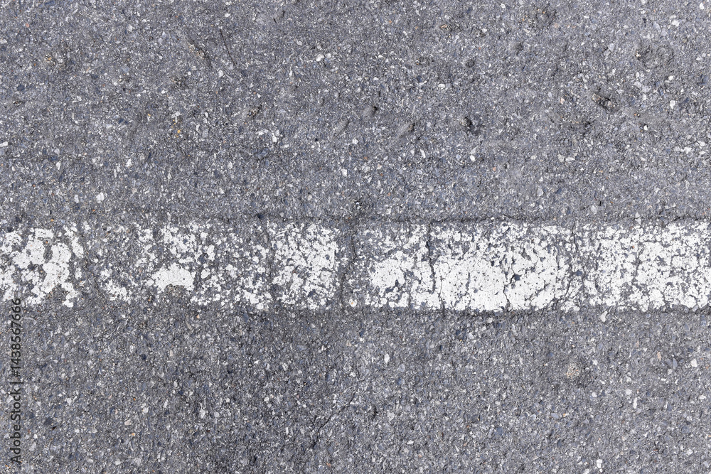 Fototapeta premium horizontal worn white dividing line painted on grey asphalt highway road