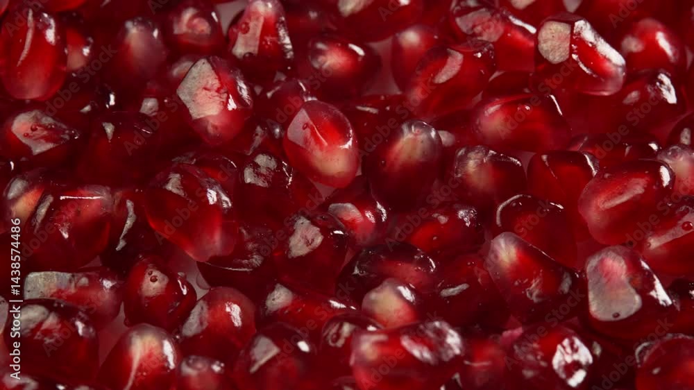 Juicy pomegranate seeds rotate as background showcase side view. Ruby pomegranate grains in low light or garnet for satisfying, advertising and promotions. Juicy grenadine fruit natural antioxidant Juicy pomegranate seeds rotate as background showcase side view. Ruby pomegranate grains in low light or garnet for satisfying, advertising and promotions. Juicy grenadine fruit natural antioxidant