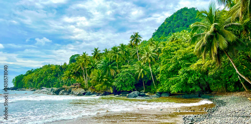 Принти на полотні Lush tropical forest and palm-covered hills meet the rocky coastline of São Tomé and Príncipe