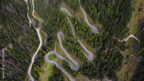 aerial view of a twisted road in a forest