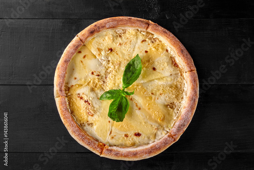 Obraz na płótnie Delicious four cheese pizza with basil on black wooden table w salonie