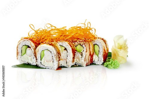 Obraz na płótnie Sushi rolls with eel, avocado, cream cheese, shrimp and sesame seeds lying on a banana leaf w salonie