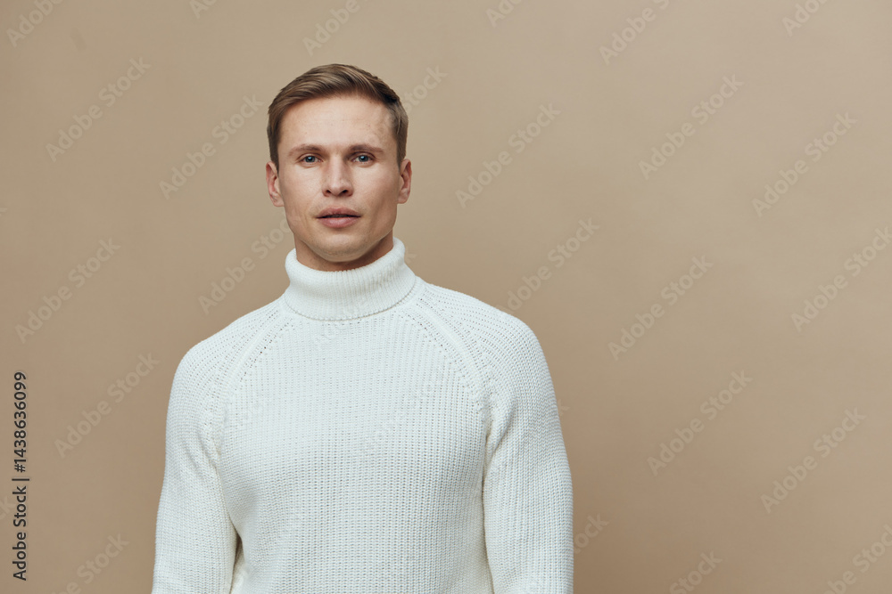 serious man in white turtleneck sweater look camera neutral facial expression beige background studio portrait winter fashion concept serious man in white turtleneck sweater look camera neutral facial expression beige background studio portrait winter fashion concept