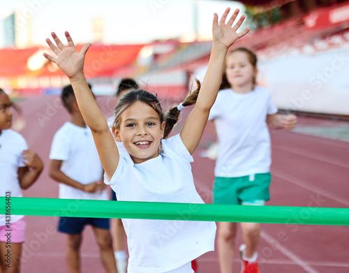 Fototapeta Naklejka Na Ścianę i Meble -  child sport athlete competition running race victory success win winner exercise sprinting runner achievement finish line finish celebration challenge happiness winning motivation excitement