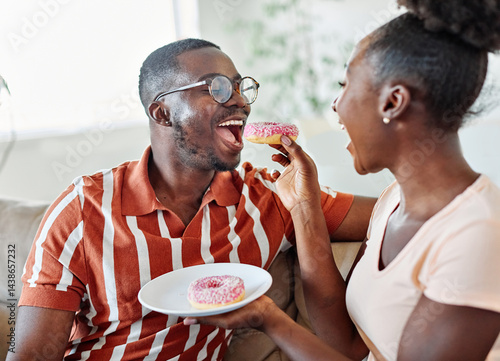 woman couple man happy love young sharing food donut together romantic eat eating cheerful girl romance boyfriend girlfriend doughnut dessert sweet two bonding