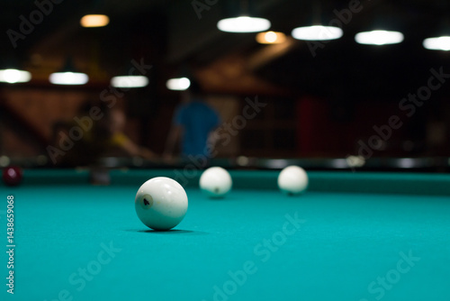 Russian billiard in club: white balls on green table cloth