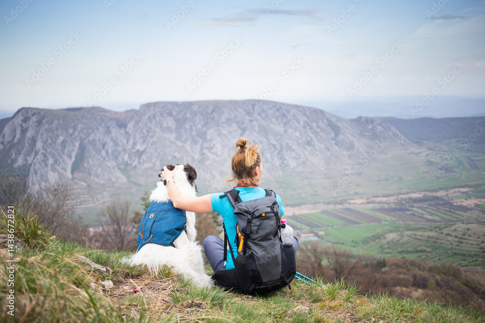 fit woman hiking with her dog
