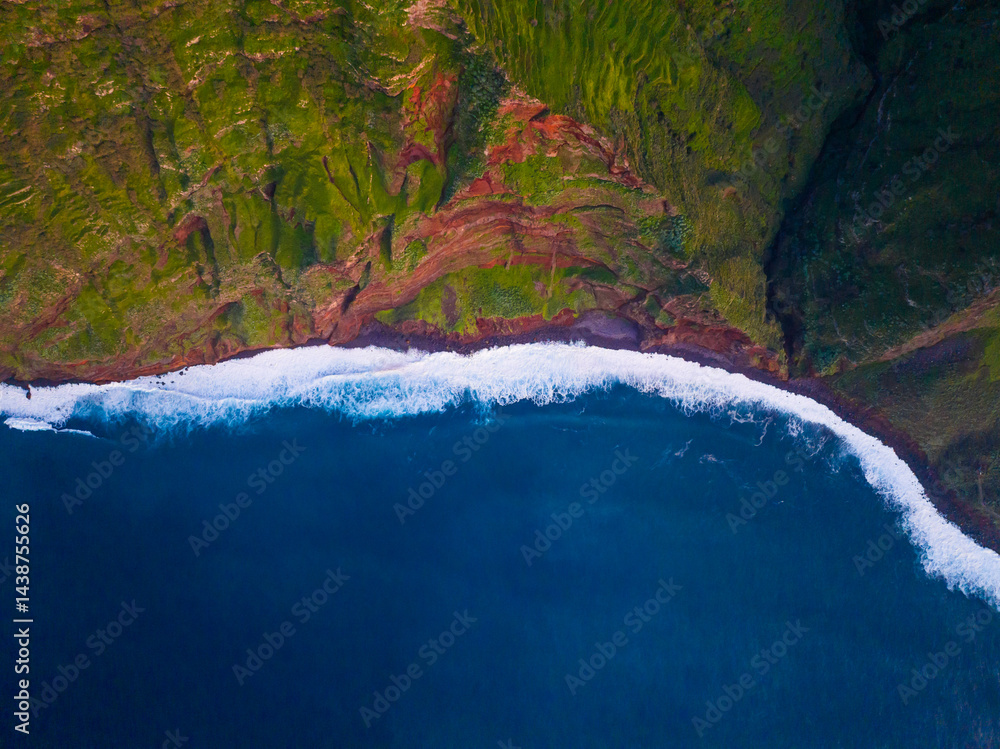 Majestic coastal cliffs meet vibrant blue waves at sunrise along an untouched shoreline, revealing natures beauty and harmony