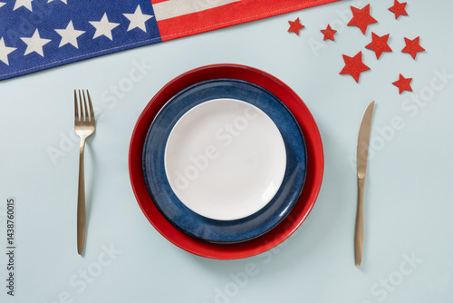 Obraz na płótnie American table setting for USA Independence Day. Festive dinner with empty white plate and decoration in USA national flag colors red and blue. View from above. Copy space. w salonie