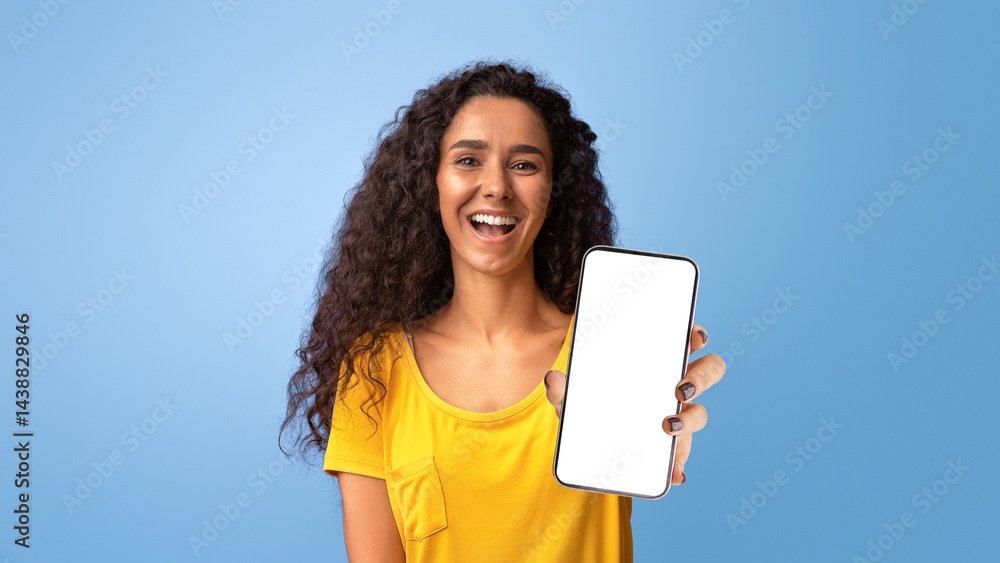 Fototapeta premium Gotcha. Positive brunette woman pointing finger at camera and laughing, joyful young curly lady indicating somebody and having fun, standing isolated over purple studio background, copy space.