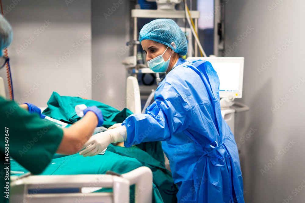 Surgeons performing surgery on patient in operating room Surgeons performing surgery on patient in operating room