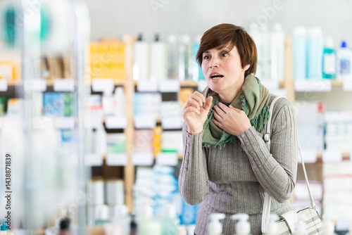 Photos Middle-aged woman struggling with strong coughing while standing in pharmacy, se