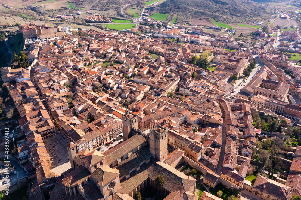 Fototapeta premium Picturesque aerial view of Siguenza townscape with residential areas, medieval Roman Catholic Catedral de Santa Maria and ancient reconstructed castle on spring day, Spain