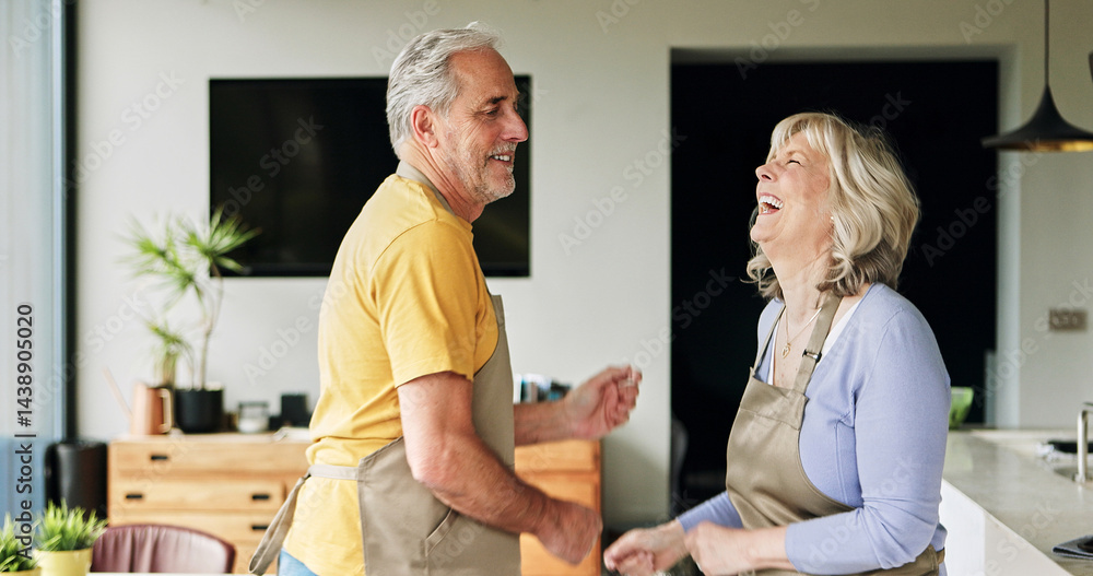 Obraz premium Senior, couple and dancing in living room or happy with bonding, retirement and marriage in apartment. Elderly, man or woman with energy for laughing, apron and romance with smile in house or home
