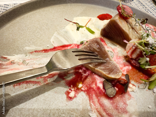 Close up of sliced beef on a fork plus raw vegetables and sweet sauce