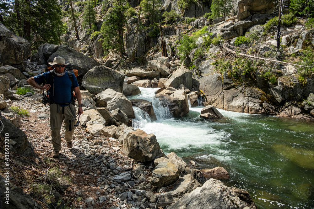 HIker Passes Rocky Cascade Along The Tuolumne River