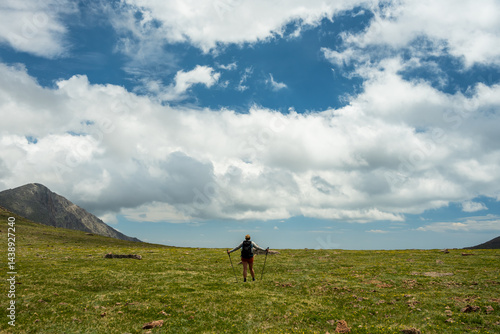 Hiker With Poles Takes In The View From Atop The Saddle In Rocky Mountain