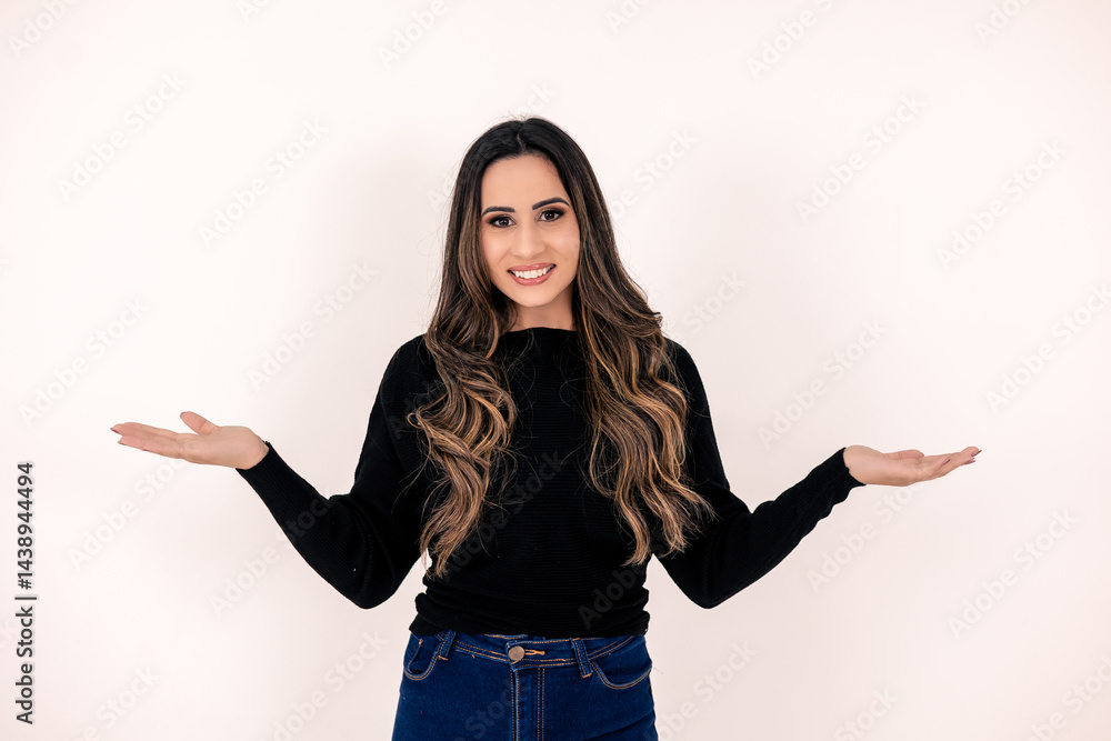 Photo of a young woman, girl, student, manager, with a happy expression, arms open, showing receptiveness, commerce, welcome Photo of a young woman, girl, student, manager, with a happy expression, arms open, showing receptiveness, commerce, welcome