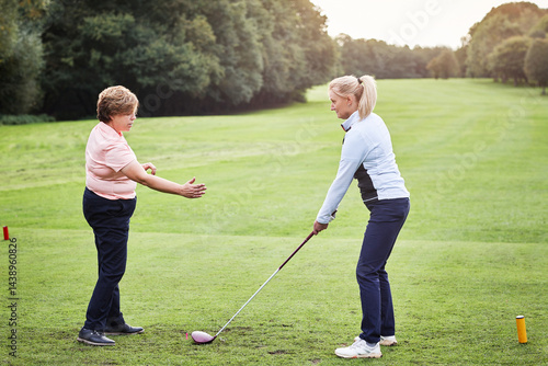 Obraz na płótnie Sports, golf and woman with personal trainer on field for game, competition and practice on golfing course. Fitness coach, equipment and people with club for training, match and learning outdoors w salonie
