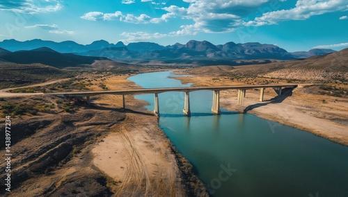 Wallpaper Mural Scenic Aerial View of Bridge Over Calm River with Mountain Backdrop Torontodigital.ca