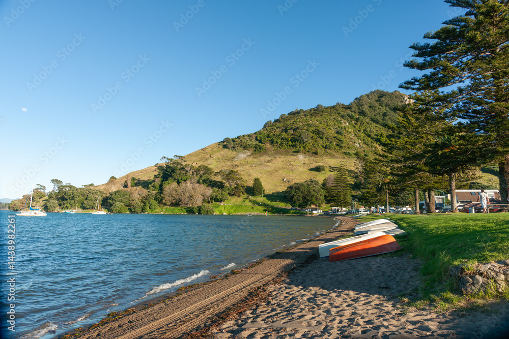 View along Pilot Bay on Mount Maunganui harbourside with landmark mountain at end.