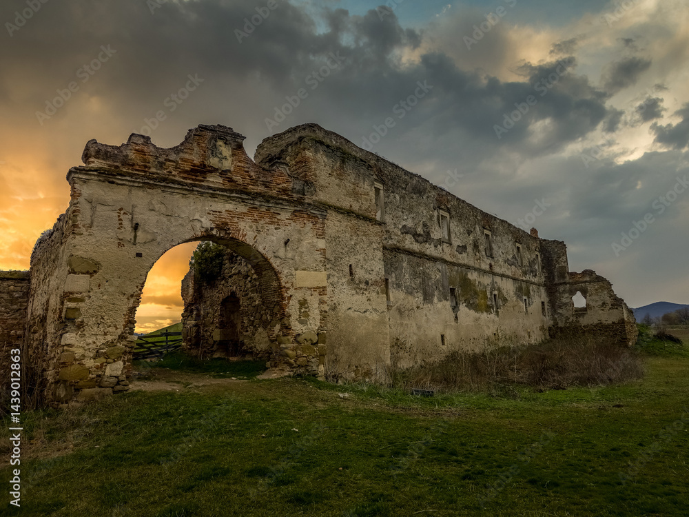 View of Alvinc Martinuzzi Castle ruin in Vintu de Jos, Transylvania Romania with colorful sunset