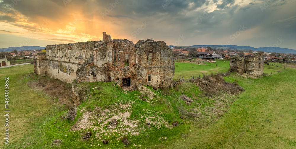 View of Alvinc Martinuzzi Castle ruin in Vintu de Jos, Transylvania Romania with colorful sunset
