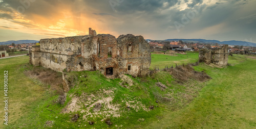 Obraz na płótnie View of Alvinc Martinuzzi Castle ruin in Vintu de Jos, Transylvania Romania with colorful sunset w salonie