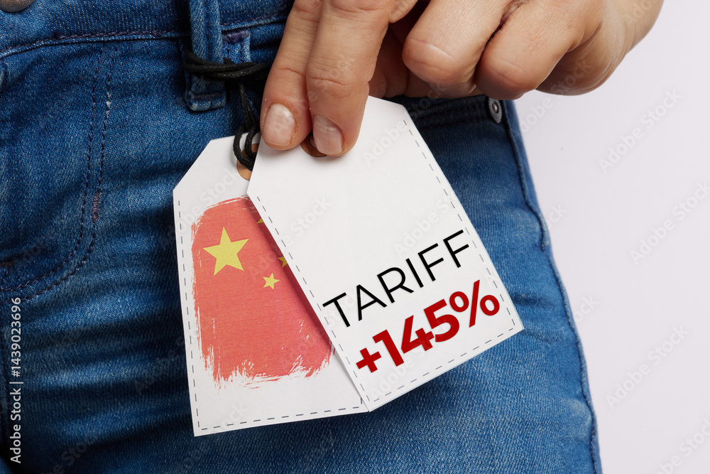 Hand Holding Jeans Price Tag with Tariff Marking