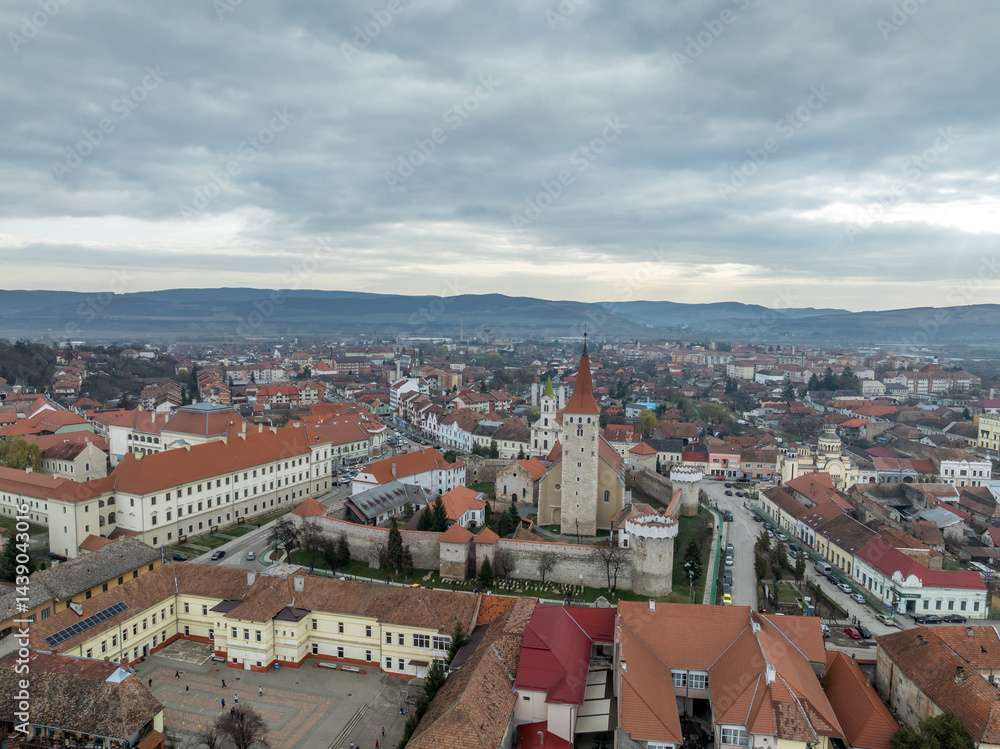 Aerial view of Aiud Nagyenyed fortified protestant church in Romania with walls and towers in the middle of the town